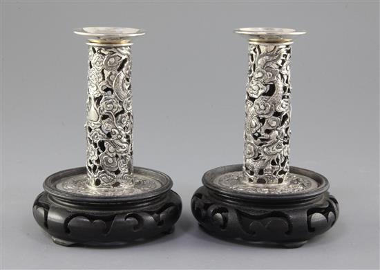 A pair of early 20th century Chinese Export repousse silver dwarf candlesticks, sticks 3.5in.